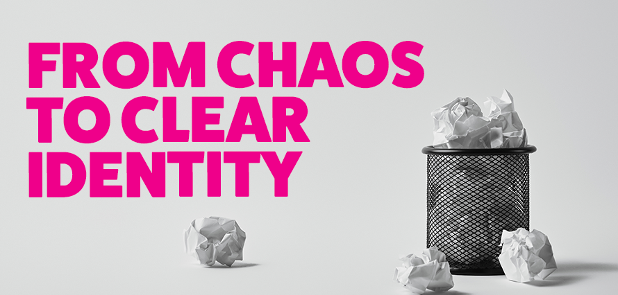 Bright pink title "From Chaos to Clear Identity" on a black and grey background of crumpled paper in trash. Blog discussing how to create visual cohesion from chaotic ideas.